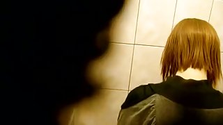 Skinny redhead with short hair, shows ass and takes a piss on a toilet