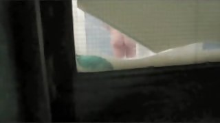 Neighbor is exposing her nice cunt through the window