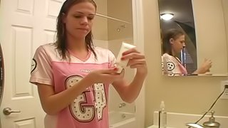 Dashing teen fairy applies her make up in front of the mirror